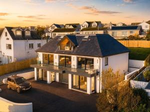 an aerial view of a house with a car in a driveway at Seaglass Point in Mevagissey
