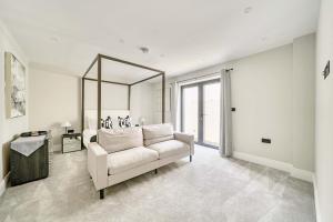 a living room with a white couch and a mirror at Seaglass Point in Mevagissey