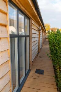 a building with windows and a wooden walkway at The Chequers at Burcot in Oxford