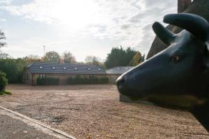 a statue of a horse head in front of a building at The Chequers at Burcot in Oxford