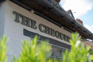 a sign on the side of a building at The Chequers at Burcot in Oxford