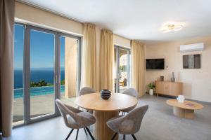 a living room with a view of the ocean at Ionian Horizon Villas in Tsoukalades