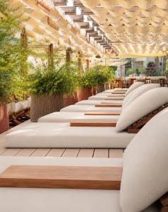 a row of pillows in a room with plants at Mare Deluxe Residences & Villas in Bodrum City +48 photos
