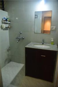 a bathroom with a sink and a mirror at UnigoOne Apartments, BH, Palolem in Canacona +75 photos