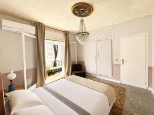 a bedroom with a white bed and a window at Seaview Beach Residence Malgrat de Mar in Malgrat de Mar +17 photos