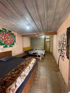 a room with two beds and a painting on the wall at Infinity Snowline , Kalga in Kalgha