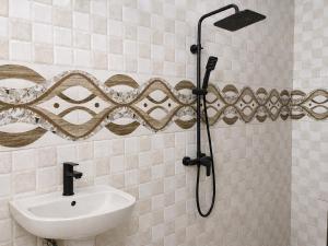 a bathroom with a shower and a sink at Jules Place Arusha in Themi +4 photos