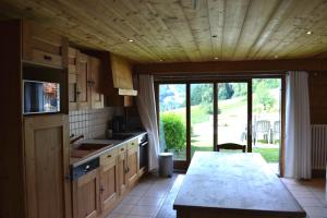 a kitchen with a sink and a large window at Chalet Fleur des Alpes 1 in Les Gets +20 photos