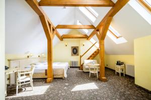 a bedroom with a bed and a table and chairs at Hotel Metamorphis in Prague