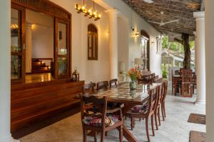 a dining room with a wooden table and chairs at Amara Villa in Galle