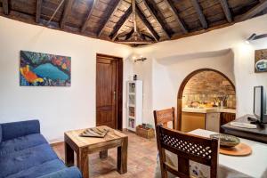 a living room with a blue couch and a table at Sabina in Mazo
