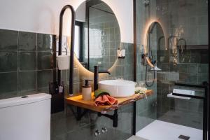 a bathroom with a sink and a mirror at Terrassi Villa in Angra do Heroísmo +30 photos