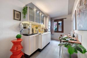 a kitchen with white cabinets and a table in it at Museum view, Vista sul museo B in Sassello