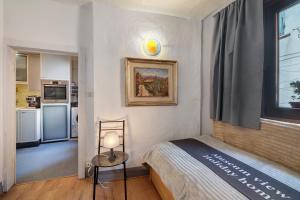 a small bedroom with a bed and a kitchen at Museum view, Vista sul museo B in Sassello +21 photos