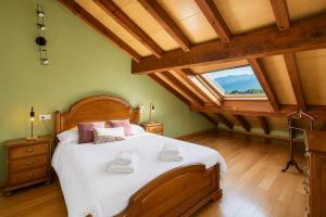 a bedroom with a large bed and a large window at Llanes Casa cerca Playa y Centro – Encina Pancar in Pancar