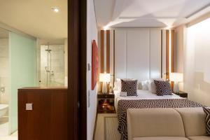 a hotel room with a bed and a bathroom at Hospes Amérigo, Alicante, a Member of Design Hotels in Alicante +80 photos