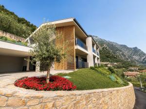 a house with a flower garden in front of it at Eos Lake House Luxury in Limone sul Garda