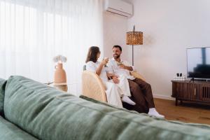 a man and a woman sitting on a couch at Terrassi Villa in Angra do Heroísmo