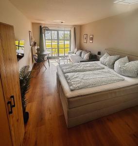 a bedroom with a bed and a living room at Apartment in Obernzell - Gästekarte inklusive in Obernzell