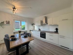 a kitchen with a table and a dining room at Zur Sonnenseite in Oberthal