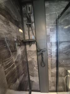 a shower with a glass door in a bathroom at Douce Escale in Vichel
