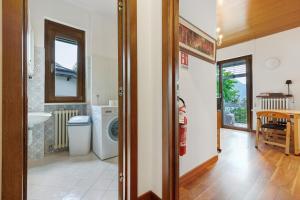 a bathroom with a sink and a washing machine at Villa Ulrica in Nago-Torbole +38 photos
