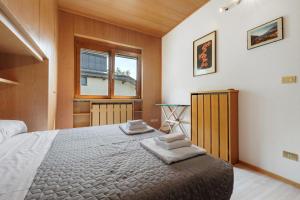 a bedroom with a large bed and a window at Villa Ulrica in Nago-Torbole