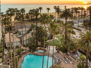 an aerial view of a resort with a pool and palm trees at Fairmont Miramar Hotel & Bungalows in Los Angeles