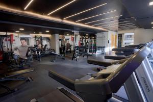 a gym with a bunch of treadmills and machines at S4 Hotel Águas Claras in Brasília