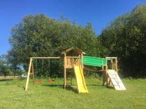 a playground with a slide and a swing at Fonclaire Holidays in Blond