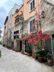 a street with flowers and flags on a building at Old Town Moschetti 20 in Corato