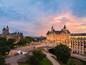 a view of a city at sunset with buildings at Fairmont Chateau Laurier in Ottawa