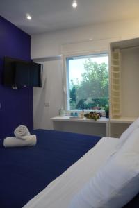 a bedroom with a bed with a blue wall at MIja Sunset home in Praiano