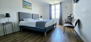a bedroom with a bed and a chair in it at Notre Dame Du Laus in Saint-Étienne-le-Laus