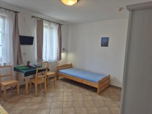 a room with a bed and a table and chairs at Pension Camp Prager in Prague