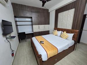 a bedroom with a bed and a television in it at GT Homestay in Chennai