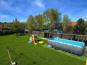 a backyard with a swimming pool and a playground at NADMORSKI RESORT in Niechorze