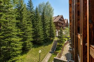 a view from a building of a yard with trees at Hostdomus-La casa di Luna in Grange Sises