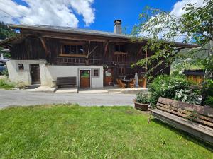 a wooden house with a bench in front of it at Chalet Lisa B&B in Morzine
