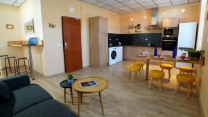 a living room with a couch and a kitchen at Notre Dame Du Laus in Saint-Étienne-le-Laus