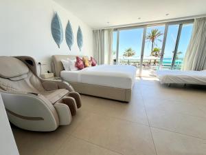 a hotel room with a bed and a chair at The Hype Beachhouse in Playa de Palma