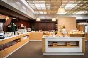 a kitchen with a counter with food on it at Hotel Adamantino in Luhačovice
