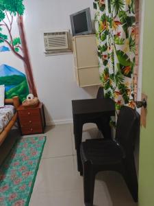 a living room with a couch and a chair at The Cronin Residence in Oslob