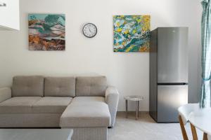 a living room with a couch and a refrigerator at Apartmani Natal in Donja Lastva