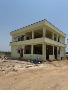 a man walking in front of a house at Sagara Darshanam in Vetāpālem