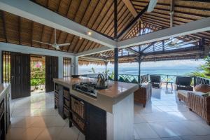an open kitchen with a view of the ocean at Villa Atas Lembongan in Nusa Lembongan +47 photos