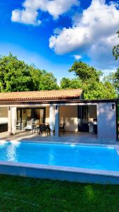 a house with a swimming pool in front of a house at Vila Green Silence in Pazin