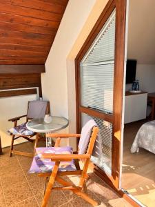 a room with a table and a chair and a window at Villa NOVA Dębki in Dębki