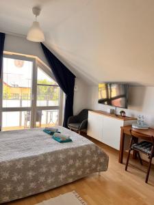 a bedroom with a bed and a large window at Villa NOVA Dębki in Dębki