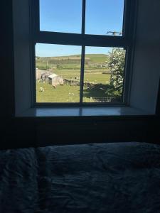 a window in a bedroom with a view of a field at Self contained property in Cartworth +6 photos